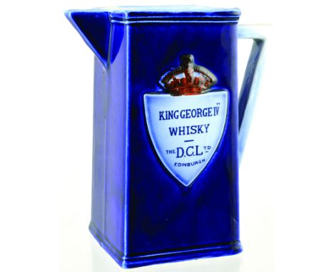 EDINBURGH D.C.L. WHISKY JUG. 6.25ins tall, strong cobalt blue glaze, variating colour on handle & lip. Raised shield & crown 