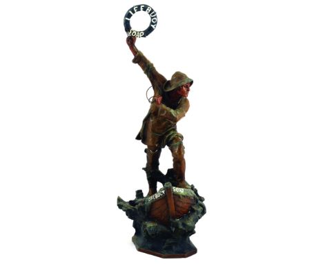 LIFEBUOY SHOP DISPLAY FIGURE. 20.5ins tall. Magnificent spelter figure of fisherman in full gear, casting out lifebuoy atop b