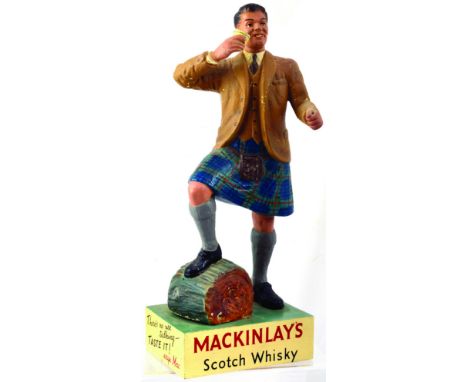 MACKINLAYS BACK BAR STATUETTE. 14ins tall, realistically modelled kilted Scotsman, toasting a wee dram, foot on tree trunk. R