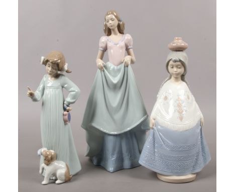 Three Nao porcelain figures one of a Mexican girl, one formed as a young girl and puppy, the other as a woman in a dress.