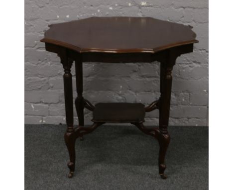 A mahogany window table with reeded supports.