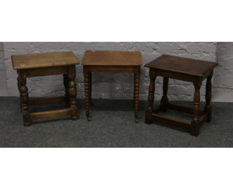 Two vintage carved and turned oak stools, along with mahogany bobbin turned castered leg stool.&nbsp;