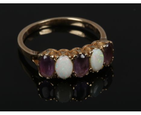 A 9ct gold opal and amethyst four stone ring, size Q1/2.