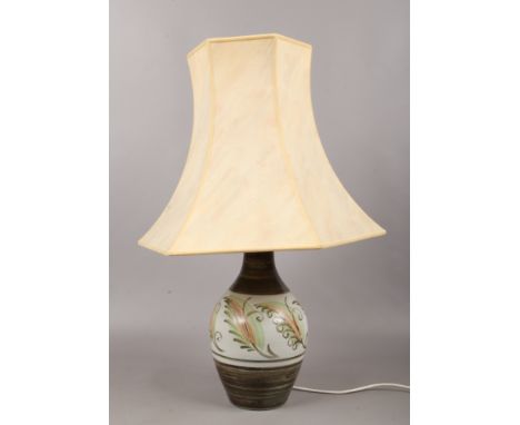 A studio pottery table lamp of baluster form with cream shade.