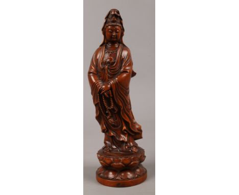 A Chinese carved boxwood statue of Guanyin Goddess raised on a lotus pedestal.