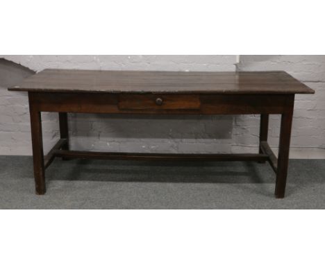 A vintage carved oak plank top table with cutlery drawer, 200cm x 83cm.