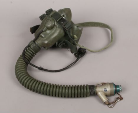 An RAF green rubber type A - 13A oxygen mask with straps dated March 1954 and with military broad arrow mark.