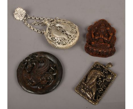 Four oriental pieces including altered jade pendant and a white metal pierced scent bottle.