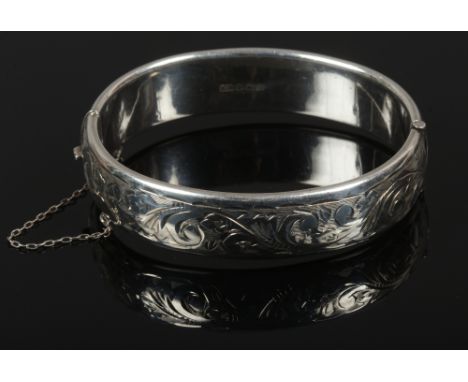 An engraved silver bangle by Charles Horner, assayed Birmingham 1968.
