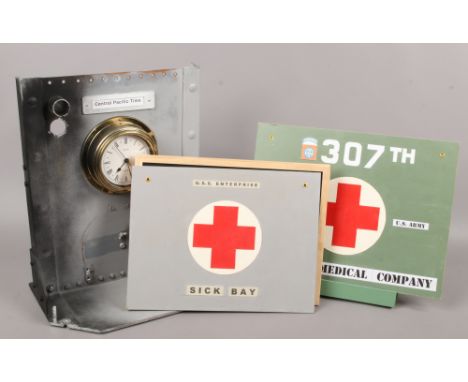 A quantity of replica world War II US military props, a navy shipboard style wall clock on bulk head style mount, along with 