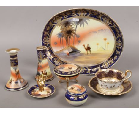 A Noritake dressing table set decorated with blue and gilt border, desert scene to include candlestick, ring stand etc.Condit