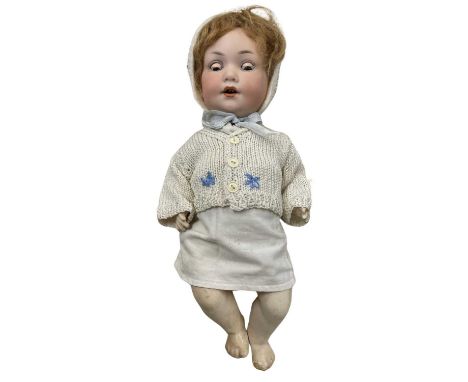 An Armand Marseille bisque head character doll, with brown weighted eyes and open mouth with teeth showing.Marked to rear of 