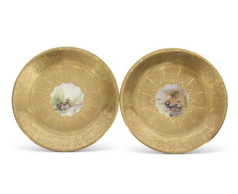 Pair of Royal Worcester plates, both with gilt designs and central panel decorated with ducks by M Morris, one entitled 'Gadw