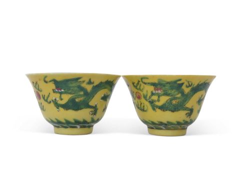 Pair of small Chinese bowls, the yellow ground decorated in famille vert enamels with dragon chasing the flaming pearl, red s