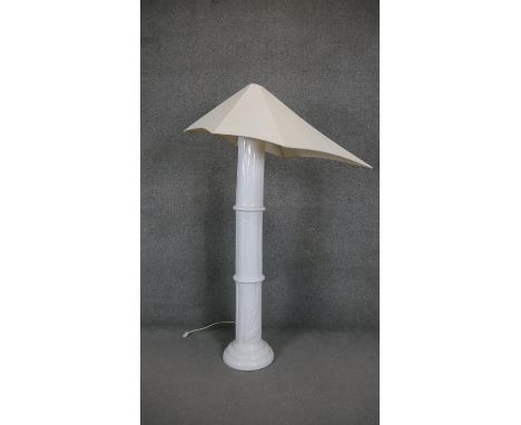 A French white ceramic bamboo design standard lamp with abstract triangular canvas shade. Makers label to the base. H.157CM 