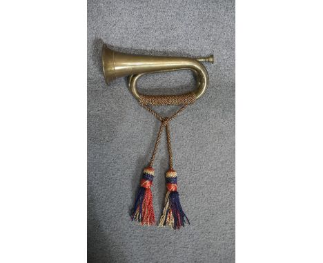 A military brass bugle with silk brocade tassles. L.30cm 