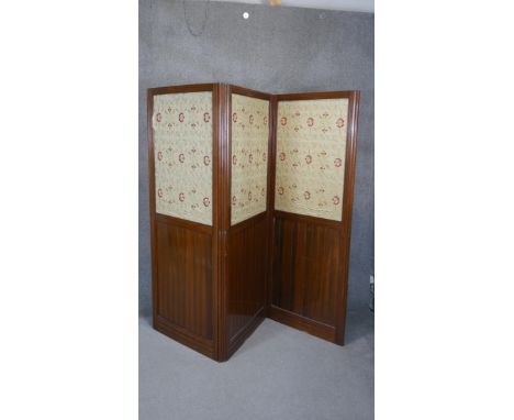 A late 19th century walnut two fold three panel room divider with inset floral tapestry panels. H.180 W.72 (Each panel) 