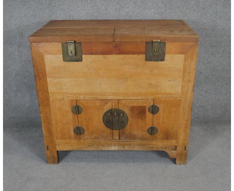 A solid light elm Korean cabinet with lift off panels to upper section above panel doors to cupboard with iron mounted handle