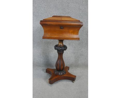 A William IV rosewood tea caddy converted to a work table with sarcophagus form fitted top above reeded baluster form pedesta