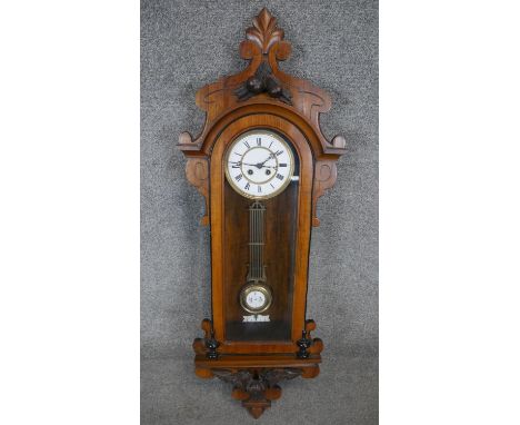 A 19th century Vienna regulator wall clock with eight day movement and white enamel dial in a carved walnut and ebonised case