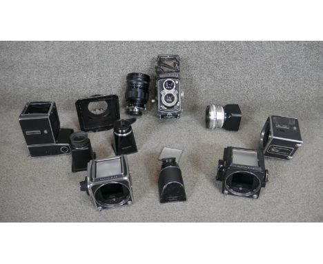 A Roliflex camera along with various Hassleblad camera parts including a Hassleblad 500EL/M camera and 500c camera parts. 