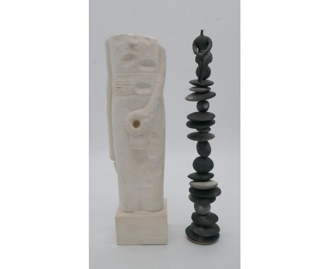 Two sculptures. One of a replica of the predynastic statue of Min from the Ashmolean museum in Oxford and a ceramic figure se