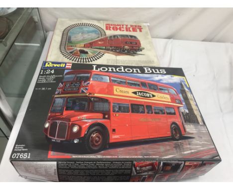 A Revel 1:24 bus model kit; together with a Mighty Red Rocket train set