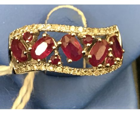 A 14ct diamond and ruby filigree ring