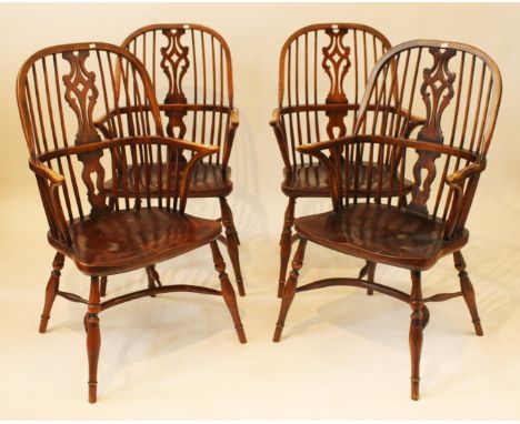 A set of four reproduction elm seated stick back carver chairsWith turned legs and crinoline stretchers, height 103cm, width 