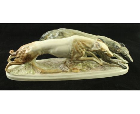 An Art Deco Goldscheider ceramic figure groupModelled in the form of two running borzoi dogs, printed factory marks to base a