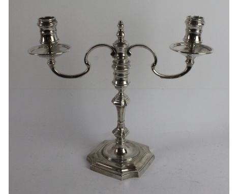 A pair of modern silver two branch, two light candelabraWith knopped stems, on raised square bases within curved corners, spo