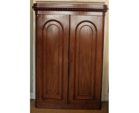 A large Victorian mahogany wardrobeMoulded cornice above two doors with arched decoration, the interior with hanging space an