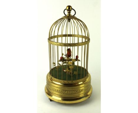 A 20th Century Swiss clockwork automaton singing bird in cageMarked to base Ivolene, 30cm high 