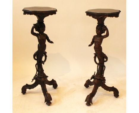 A pair late 19th Century Italian carved softwood jardiniere/lamp tablesThe stems formed as figures holding bunches of grapes 