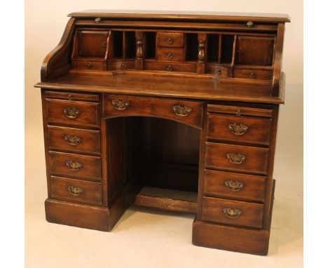 An early 20th Century oak twin pedestal roll top deskThe top section with fitted interior over a base with one long drawer ov