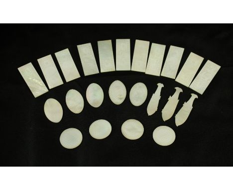 A collection of Chinese mother of pearl gaming countersTo include various shaped examples to include rectangular, fish, oval 