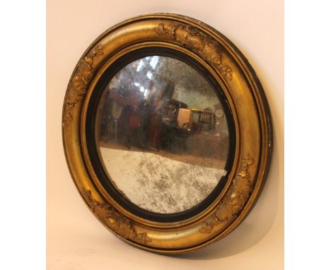 A 19th Century convex porthole style mirrorIn gilt foliate moulded frame, diameter 67cm.   CONDITION REPORT:  Much loss of si