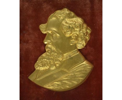 [DICKENS, CHARLES] A 19TH CENTURY FRAMED GILT-METAL PORTRAIT OF DICKENS In high relief, facing left, mounted on red velvet an