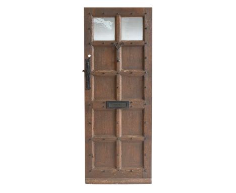 Robert Mouseman Thompson (1876-1955): An English Oak Panelled Front Door, with two frosted glass panels, wrought iron studs, 