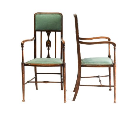 A Pair of Art Nouveau Stained Beech Salon Arm Chairs, upholstered back above an inlaid splat, upholstered seat, on spindle fr