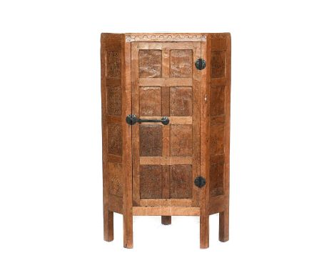 Robert Mouseman Thompson (1876-1955): An English Burr Oak Panelled Floor Standing Corner Cupboard, 1930's, penny moulded top,