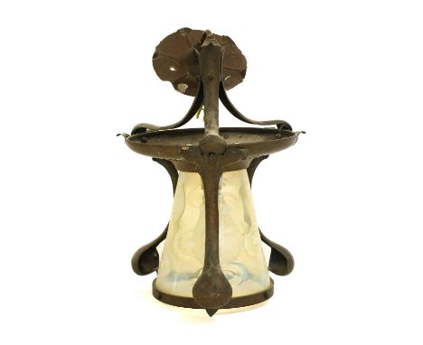 An Arts &amp; Crafts Brass Hanging Hall Lantern, circa 1900, with vaseline glass shade, the frame with pierced heart motifs, 