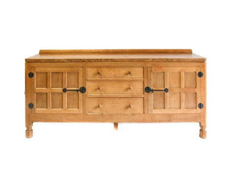 Workshop of Robert Mouseman Thompson (Kilburn): An English Oak 6ft Sideboard, 1976, with raised upstand, adzed top over two c