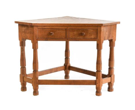 Robert Mouseman Thompson (1876-1955): An English Oak Corner Table, with two drawers with turned knob handles, on five octagon