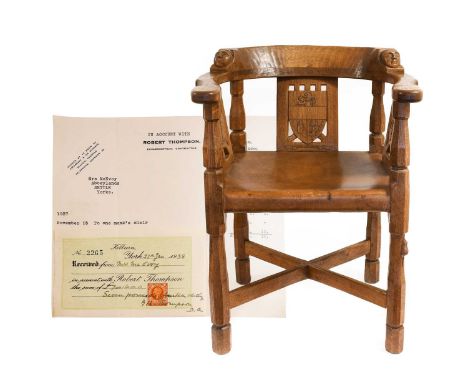 Robert Mouseman Thompson (1876-1955): An English Oak Monks Chair, 1937, with curved back and shaped arms, each side carved wi