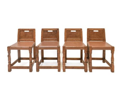 Robert Mouseman Thompson (1876-1955): A Set of Four English Oak Low Panel Back Chairs, circa 1930s/40s, with aperture to pane