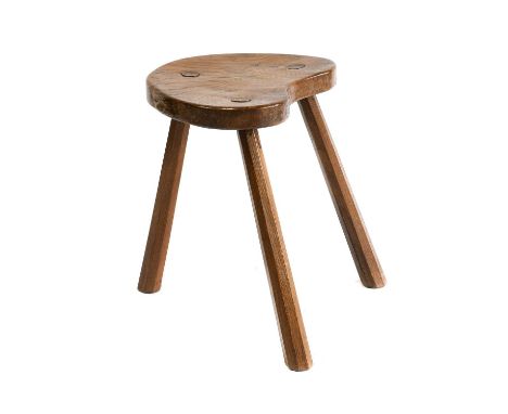 Workshop of Robert Mouseman Thompson (Kilburn): An English Oak Cow Stool, the kidney shaped seat on three octagonal legs, wit