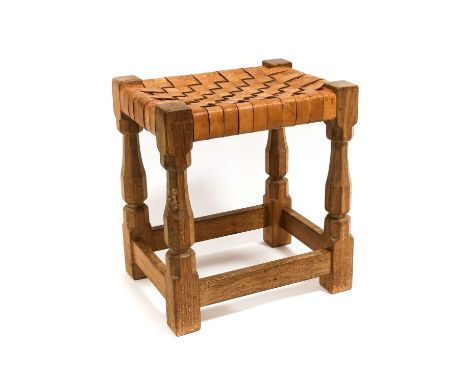 Workshop of Robert Mouseman Thompson (Kilburn): An English Oak Stool, strap leather top, on four octagonal legs joined by str