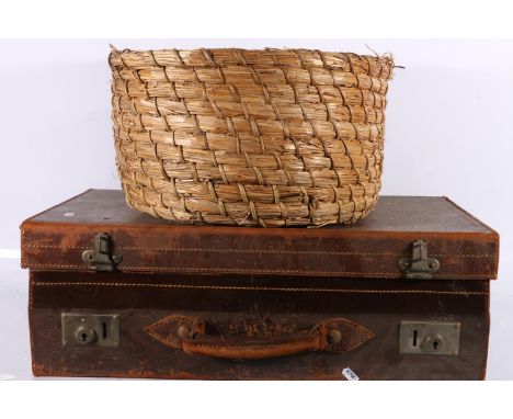 Vintage leather suitcase and a basket. 
