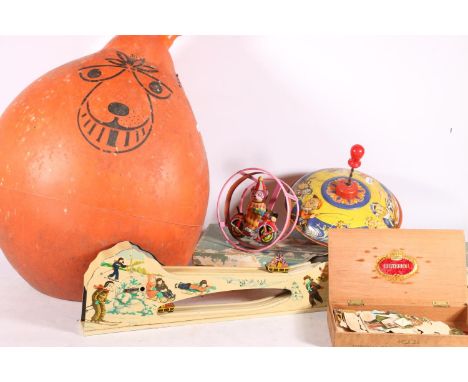 Vintage tinplate and other toys to include a spinning top, a Japanese clockwork circus toy, a space hopper, etc. 